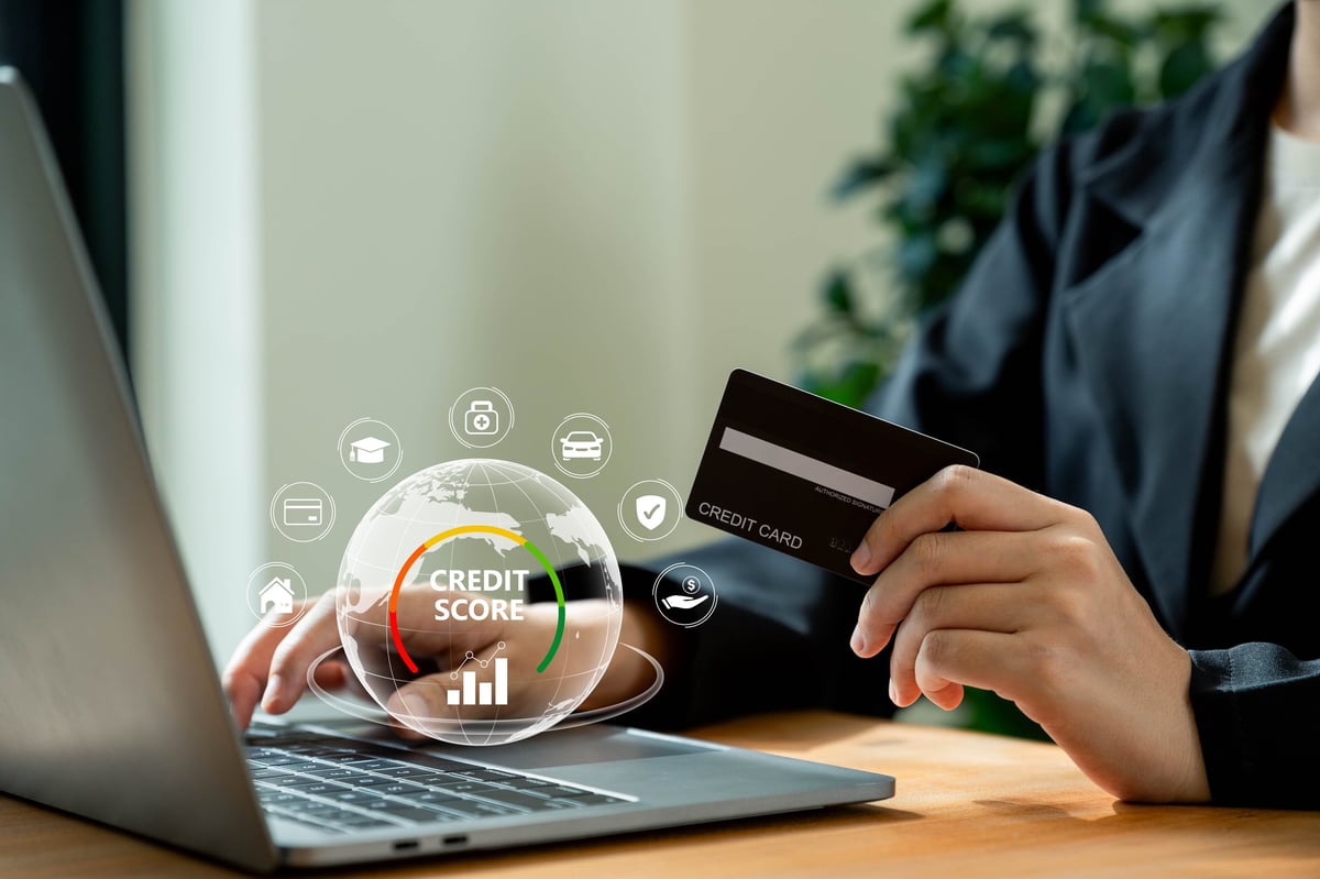 Businesswoman reviewing her credit score and payment history on a laptop