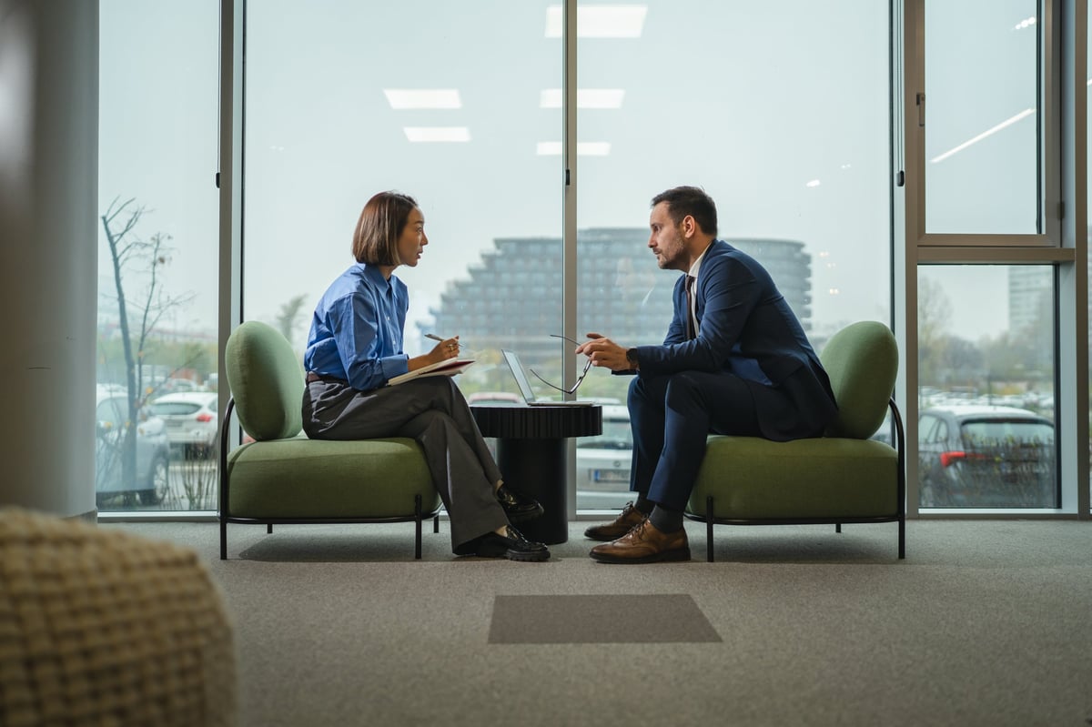 A funding specialist reviewing a client's file during a consultation